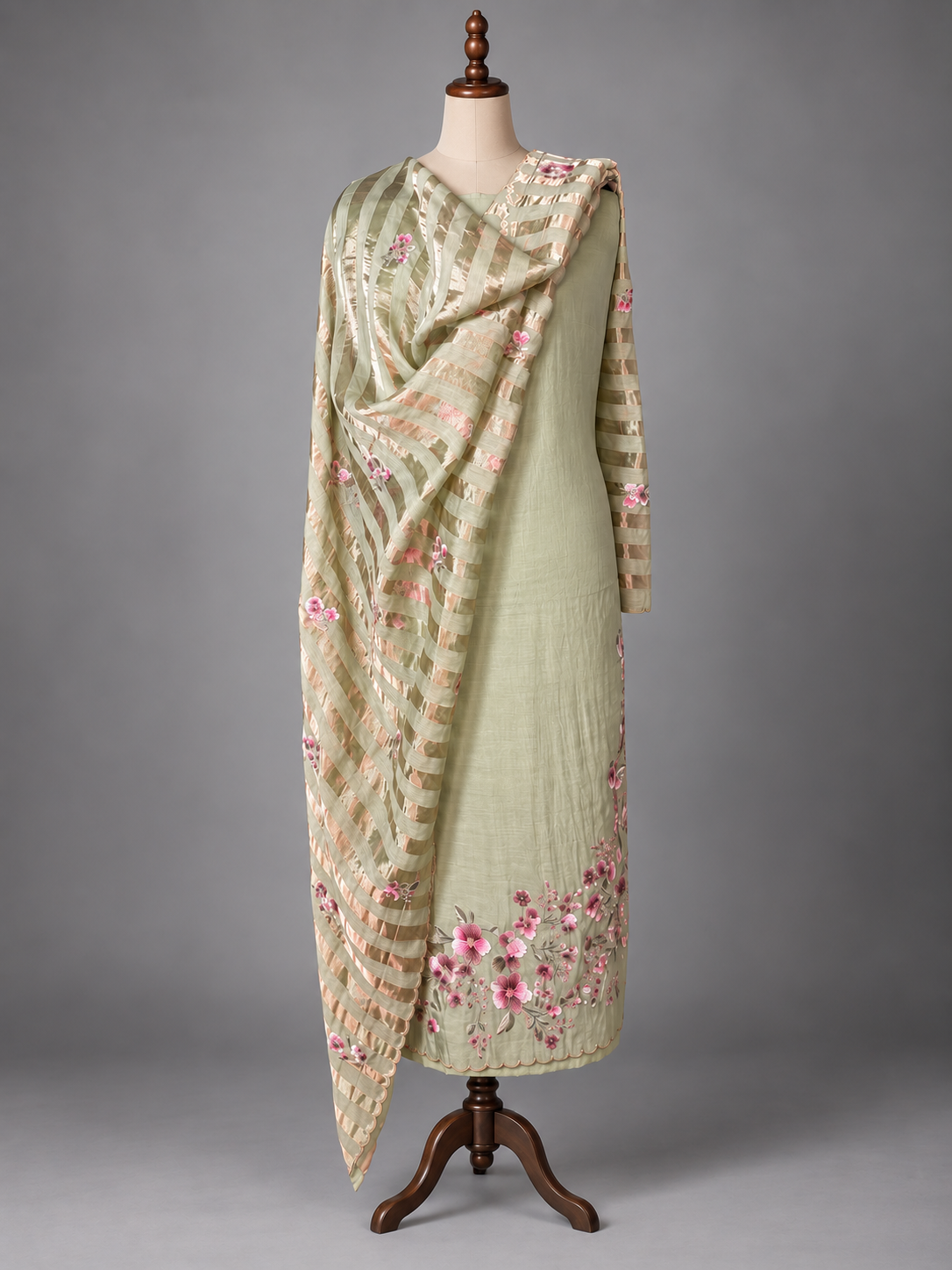 Sage green mul cotton suit set with striped dupatta draped over the shoulders