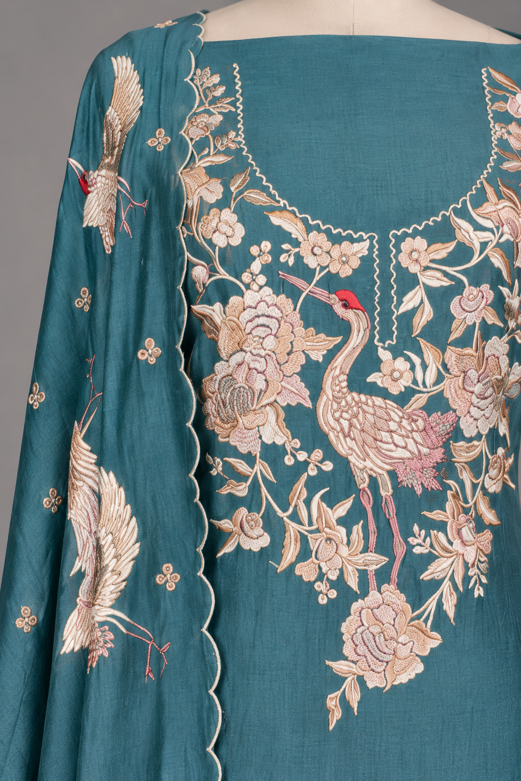 Close-up of Parsi Gara crane and rose embroidery on teal mul chanderi yoke with scalloped dupatta