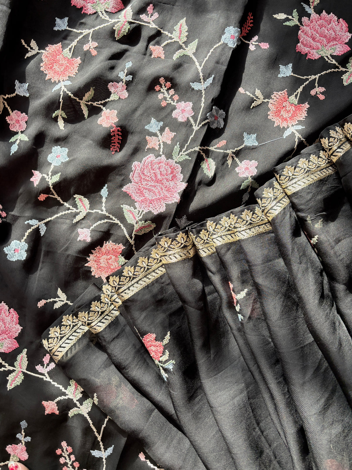 Detail of cross stitch florals and gold border on black dupatta