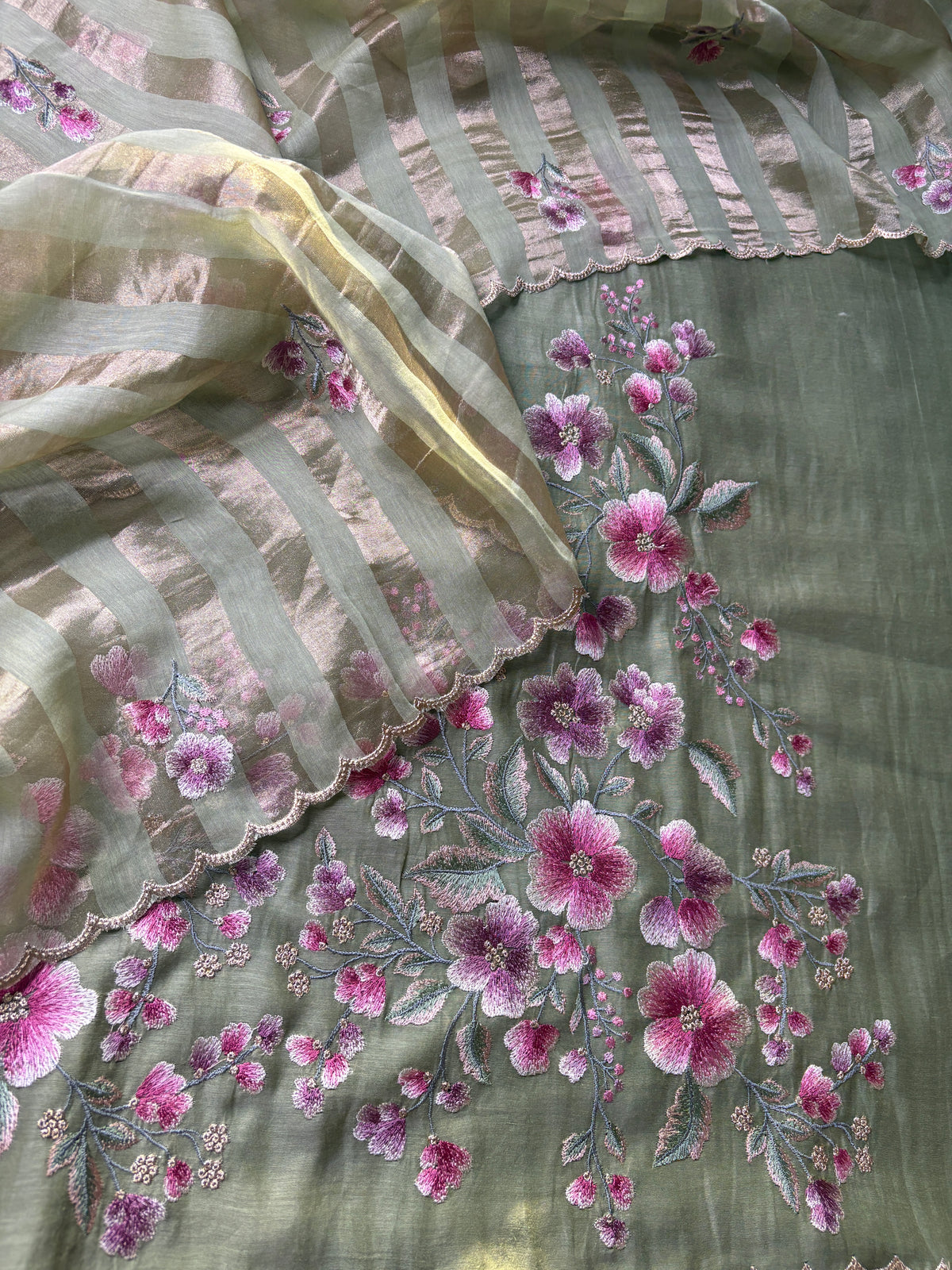 Close-up of pink and lilac floral embroidery on sage green mul cotton with scalloped striped dupatta