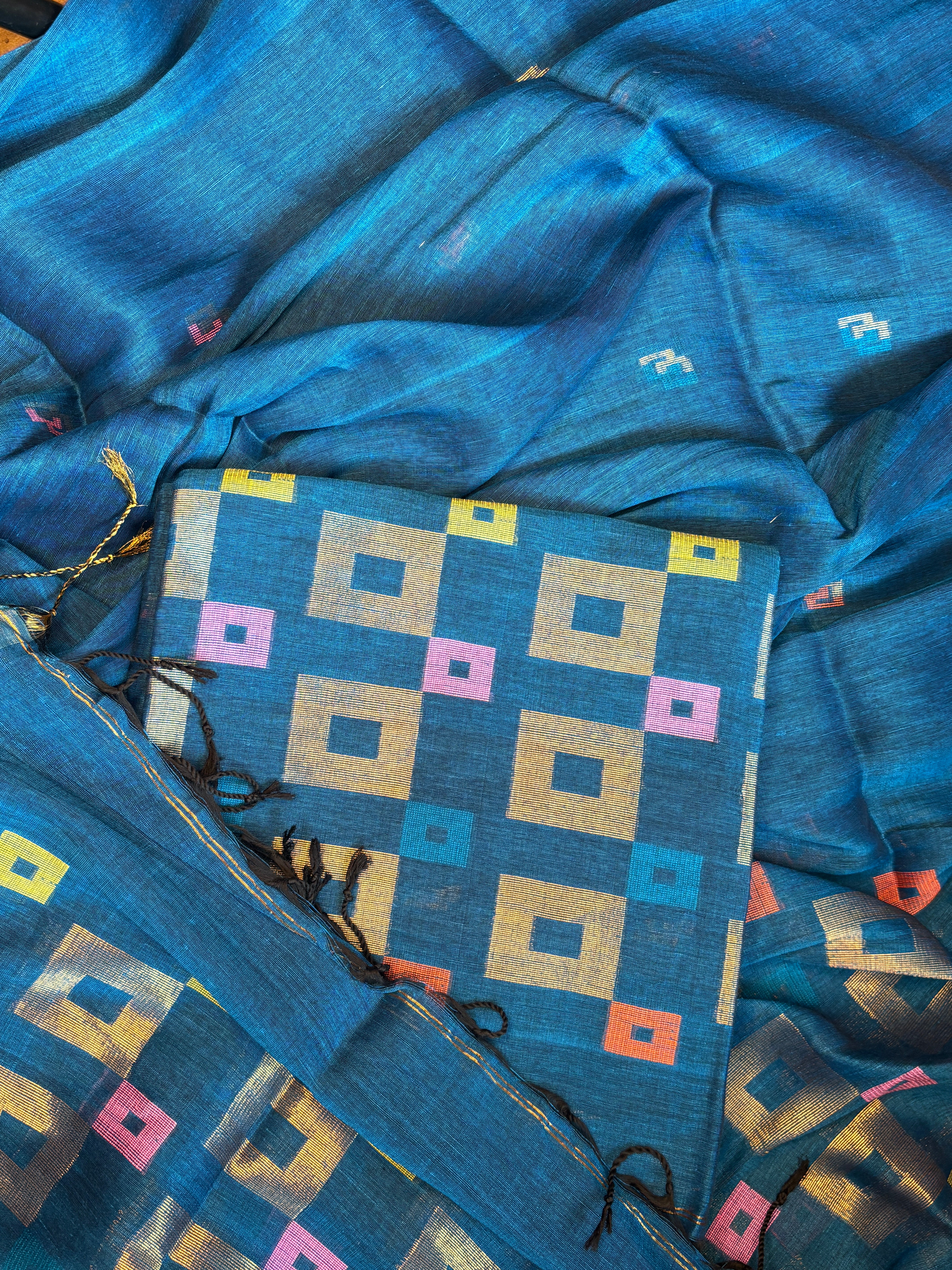 Peacock blue pure linen Jamdani suit set fabric laid flat showing full geometric pattern